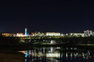 Naklejka na ściany i meble Amazing view of the night city of Mogilev across the Dnieper River. Belarus