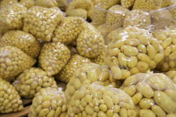 Raw potatoes in plastic bag