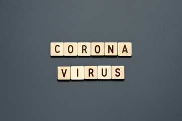 CORONAVIRUS - word from wooden blocks with letters. Top view on gray background. - Image
