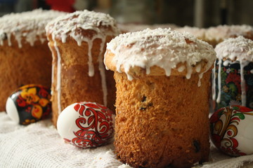 religious holiday, easter, close-up of delicious home-made festive pastries, cakes with white icing, colored eggs