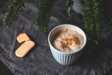 Cappuccino in beautiful cup on the table