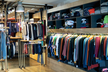 Variety of men clothes in modern garments shop