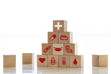 Healthcare and Medicine With Media Icons Concept, Wooden Cube From Stack on wooden table