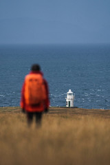 Fototapeta na wymiar Traveler at Vaternish Lighthouse