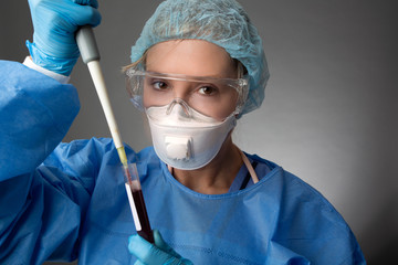 Laboratory pathologist pipetting a patient blood sample