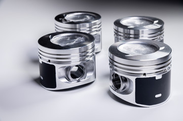 New parts for the internal combustion engine. Pistons on a gray gradient background