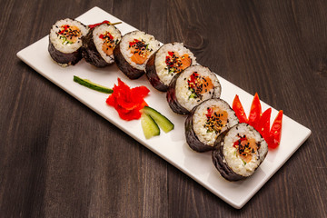 Korean roll Gimbap(kimbob). Steamed white rice (bap) and various other ingredients. Trendy black background