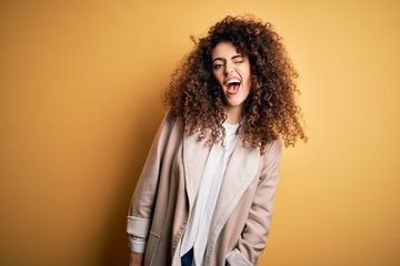 Young beautiful brunette woman with curly hair and piercing wearing casual t-shirt and diadem...
