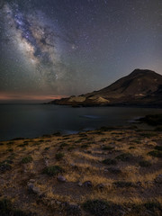Night landscape of the Almería coast with the Milky Way, on the beach of Los Escullos, in the Cabo de Gata Natural Park.