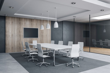 Modern meeting room interior with empty tv screen and sunlight.