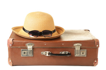 Leather old suitcase with hat isolated on white background. Travel concept