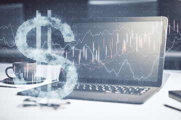 Laptop with dollar symbol and forex chart in office.