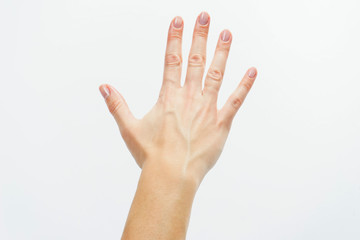 Top view: female hand with clean healthy skin on a white isolated background showing gestures