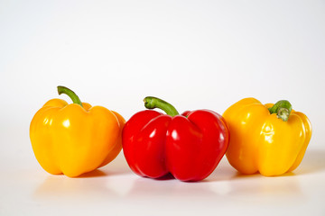 Sweet peppers yellow and red on a white background