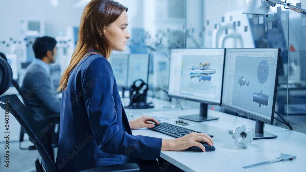Poster Over the Shoulder: Team of Mechanical Engineer Working on Personal Computers, Screens Shows CAD Software with 3D Prototype of Electric Engine, Turbine. Industrial Factory with High-Tech CNC Machinery