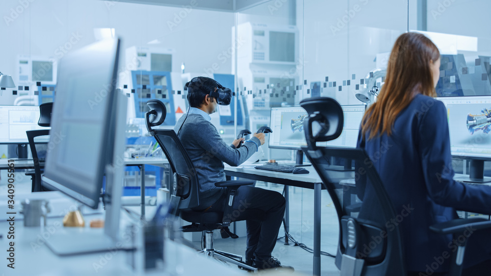 Poster Modern Factory: Industrial Design Engineer Wearing Virtual Reality Headset and Holding Controllers, Uses VR technology for Industrial Design, Development and Prototyping in CAD Software on Computer.