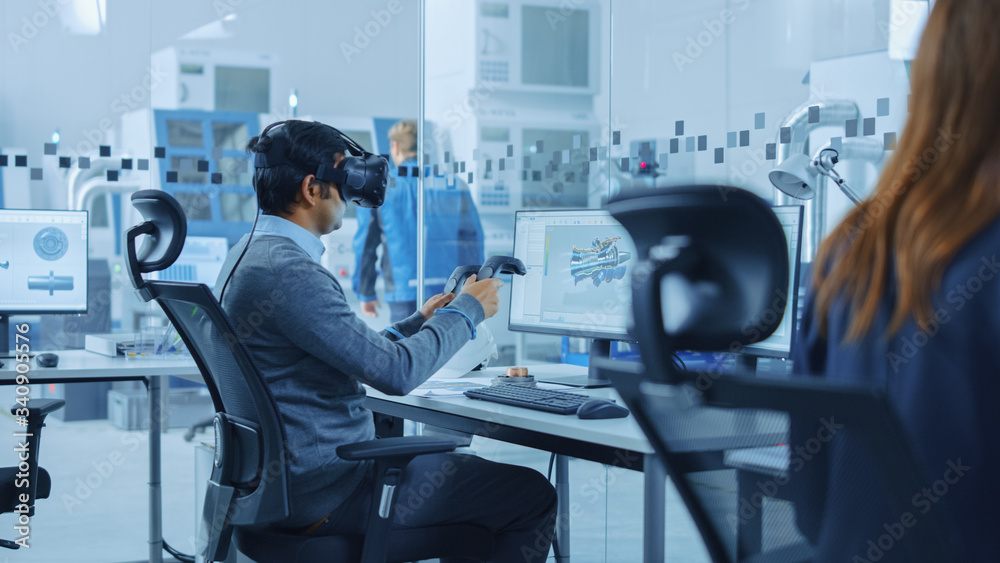 Poster Modern Factory: Industrial Design Engineer Wearing Virtual Reality Headset and Holding Controllers, Uses VR technology for Industrial Design, Development and Prototyping in CAD Software on Computer.