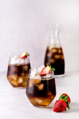 Glasses of Homemade Cold Brew Coffee to Drink for Breakfast Summer Beverage with Ice Cubes Decorated with Strawberry and Chocolate Vertical