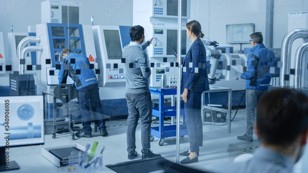 Poster Modern Factory Office: Team of Industrial Engineers Working on Computers. In Factory Workshop: Professional Workers Use High-Tech Industrial CNC Machinery, Program Robot Arm, Have Meeting.