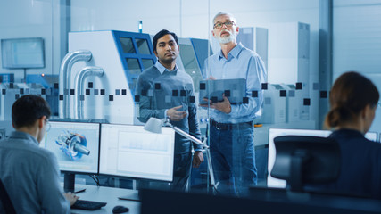 Obraz premium Automotive Design Factory: Project Manager, Chief Mechanical Engineer Talk, Use Laptop, Discuss Project Details. High-Tech Industrial Facility Construction of Engines using CNC Machinery.