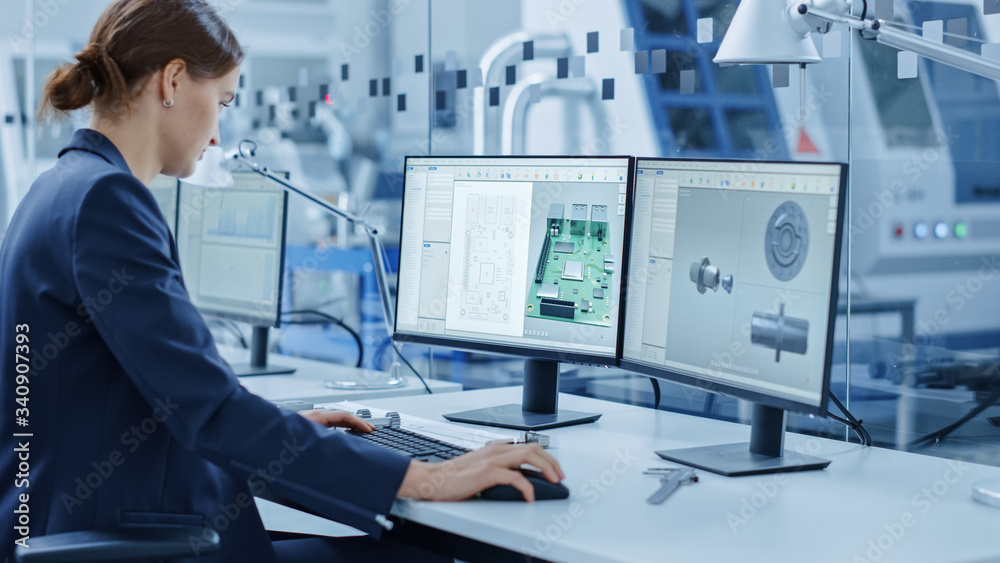 Poster Female Engineer Working on a Personal Computer, Two Monitor Screens Show Chroma Key / Green Screen Display and CAD Software with 3D Model of Industrial Machinery Mechanism. Working Modern Factory
