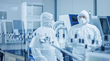 Sterile Modern Factory: Professionals in Coveralls, Masks Walk Through Workshop and Talk. Medical...