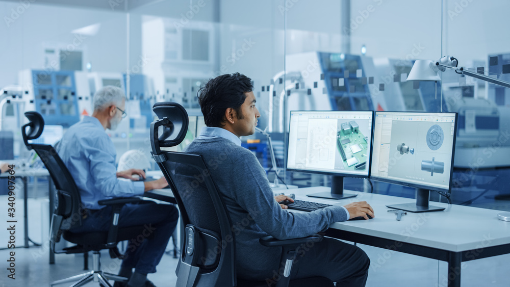Poster in clean workshop: professional workers in coveralls and masks use laptop and talk. inside factory o