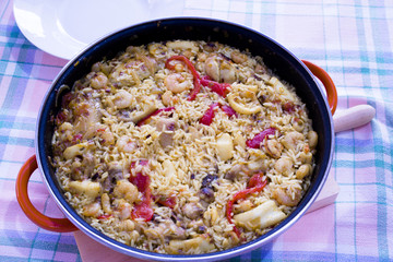 Rice paella cooked with chicken, seafood and vegetables