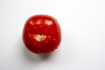 Red tomato on a white background, top view