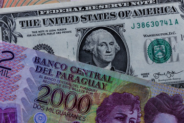 One  US Dollar with Different Paraguayan guarani Banknotes