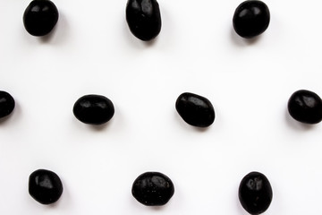 Chocolate coated peanuts on a white background