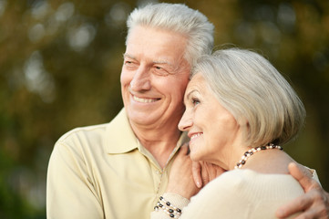 Portrait of smiling senior couple in autumn park