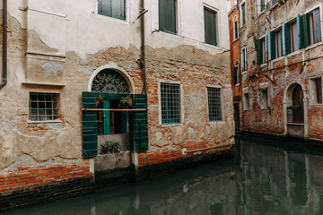 Fototapeta na wymiar Houses and water are green at the window level | VENICE, ITALY - 16 SEPTEMBER 2018. 