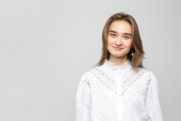 Obraz premium Beautiful young woman portrait. Studio shot, isolated on gray background