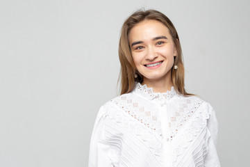 Obraz premium Beautiful young woman portrait. Studio shot, isolated on gray background