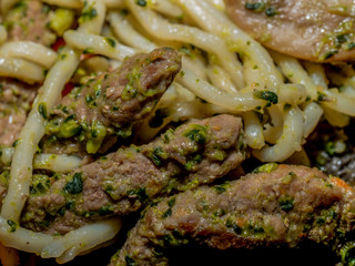 Homemade noodle with vegetables and veal. Put on the plate with the serving fork.