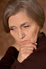 Portrait of sad senior woman at home