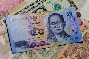 One  US Dollar with Different Thailand Baht Banknotes