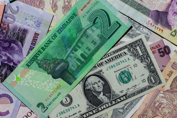 Fototapeta na wymiar One US Dollar with Different Zimbabwean dollar Banknotes