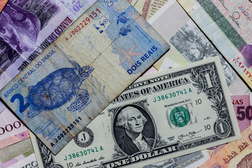 Obraz na płótnie Canvas One US Dollar with Different Brazilian Real Banknotes