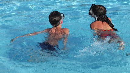 boy and girl swimming in the pool