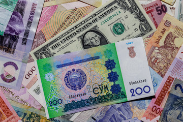Moscow, Russia - April 20, 2020: One  US Dollar with Different Uzbekistani Som Banknotes