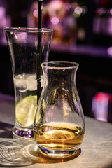 Flight of Scottish whisky, tasting glasses with variety of single malts or blended whiskey spirits on distillery tour in pub in Scotland