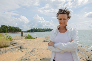 Mature beautiful woman against scenic view of the lake