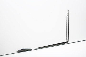 laptop and white table lamp on a glass table