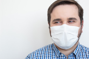 Man in a protective mask against coronavirus isolated on white. Coronavirus man mask, copyspace, copyplace, space for text. Coronavirus, illness, infection, quarantine, medical mask