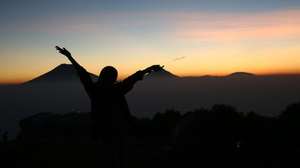 silhouette of a woman in the sunset at mount andong