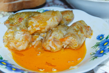  half empty plate with stuffed cabbage leaves with meat, rice and vegetables. close-up 