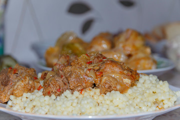 plate on the table with a dish of couscous with goat meat close-up   