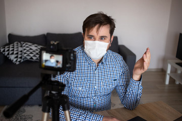 Fototapeta na wymiar Man making video blog while stay home on coronavirus quarantine